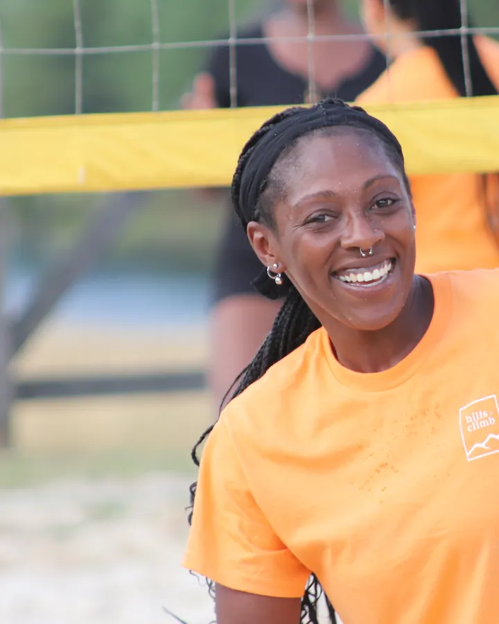 Aquira Herring smiling on the camp volleyball court