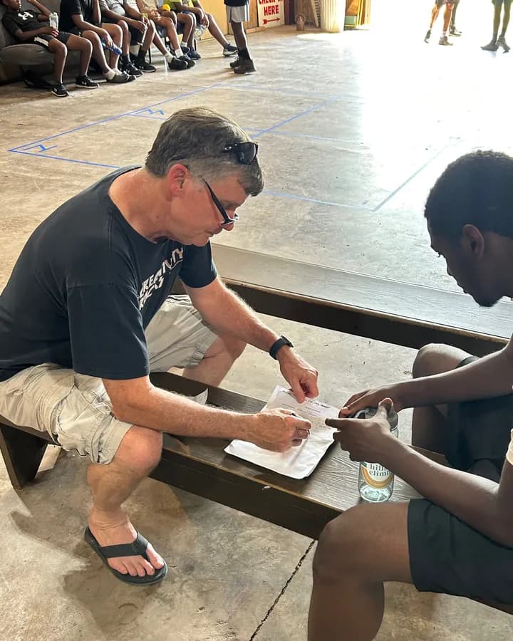 Donald Hauprich reviewing a worksheet with a camper