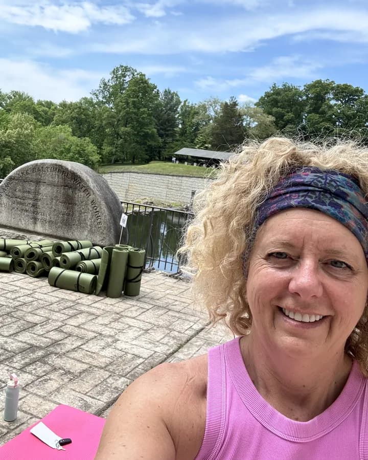 Dorinda Tucker smiling outdoors at camp