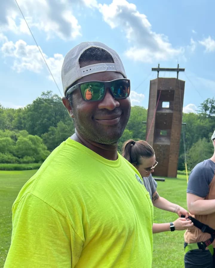 Michael Nelson in a climbing harness at the ropes course